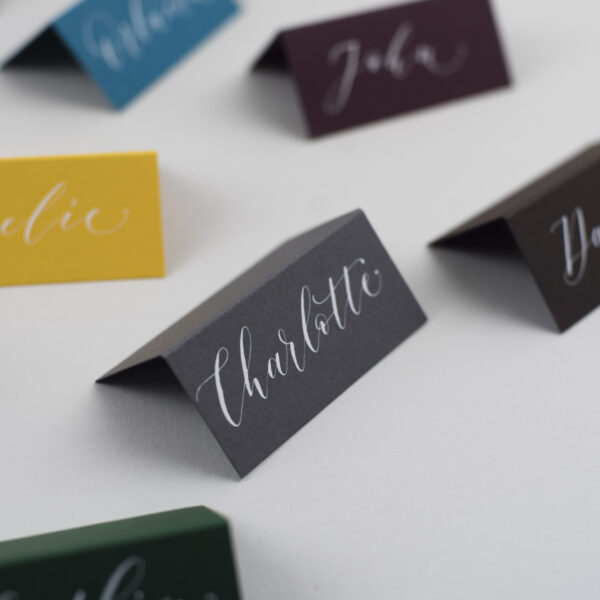 grey placecard with white calligraphy